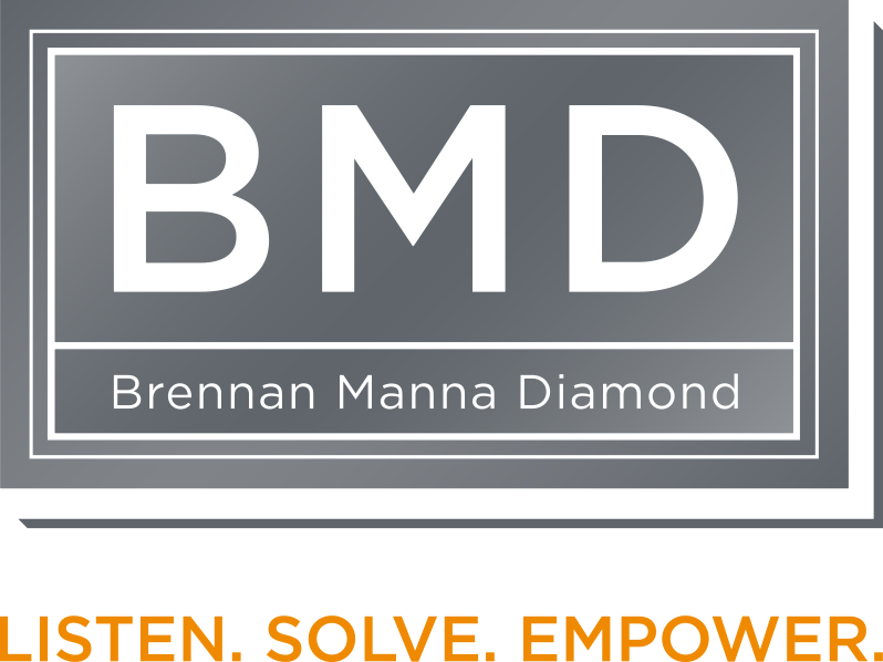 BMD Brennan Manna Diamond logo with large white 'BMD' letters above 'Brennan Manna Diamond' text in a gray rectangular frame with white borders, followed by orange text reading 'LISTEN. SOLVE. EMPOWER.